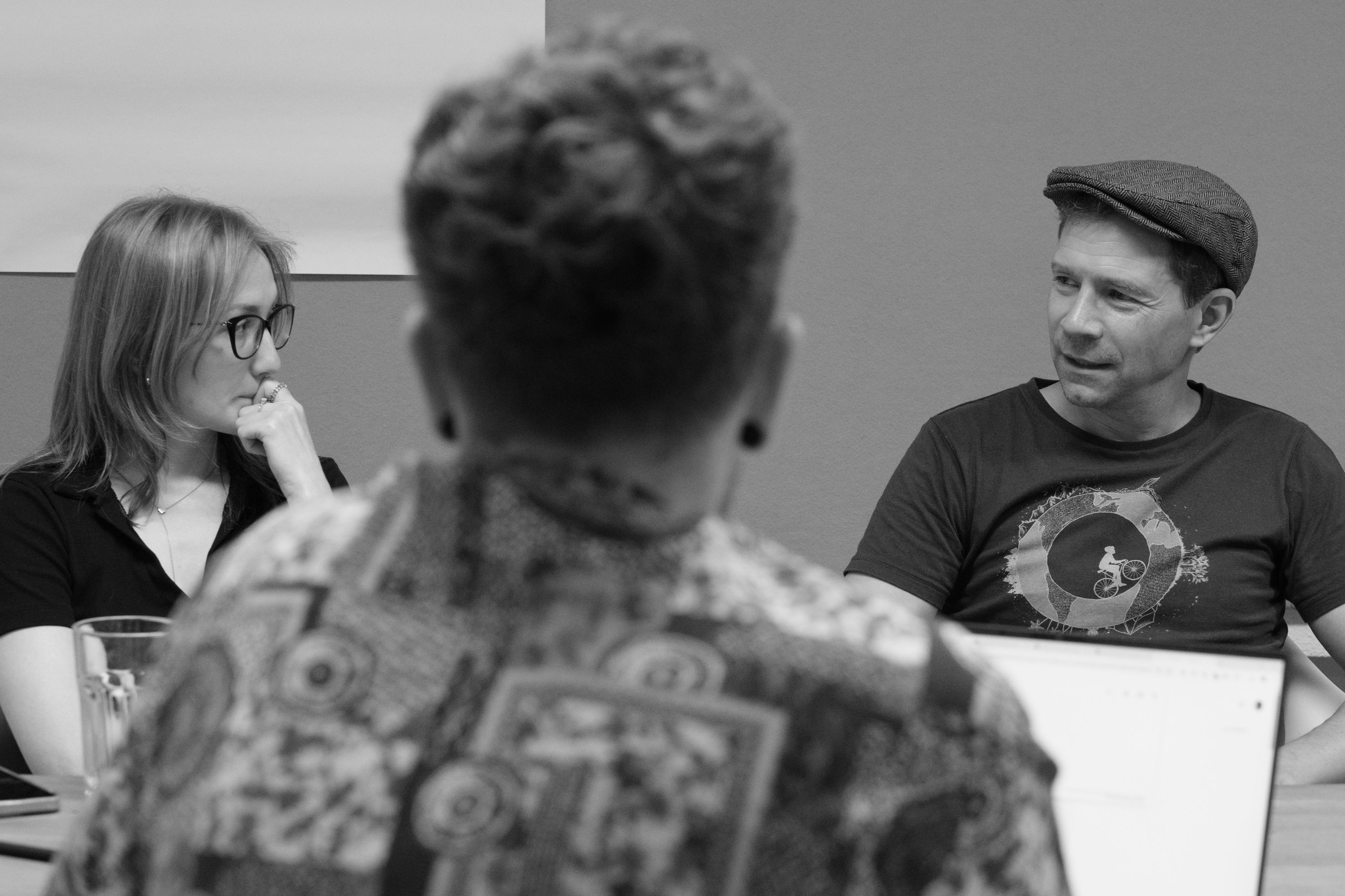 Drei Personen im Gespräch bei einem Meeting