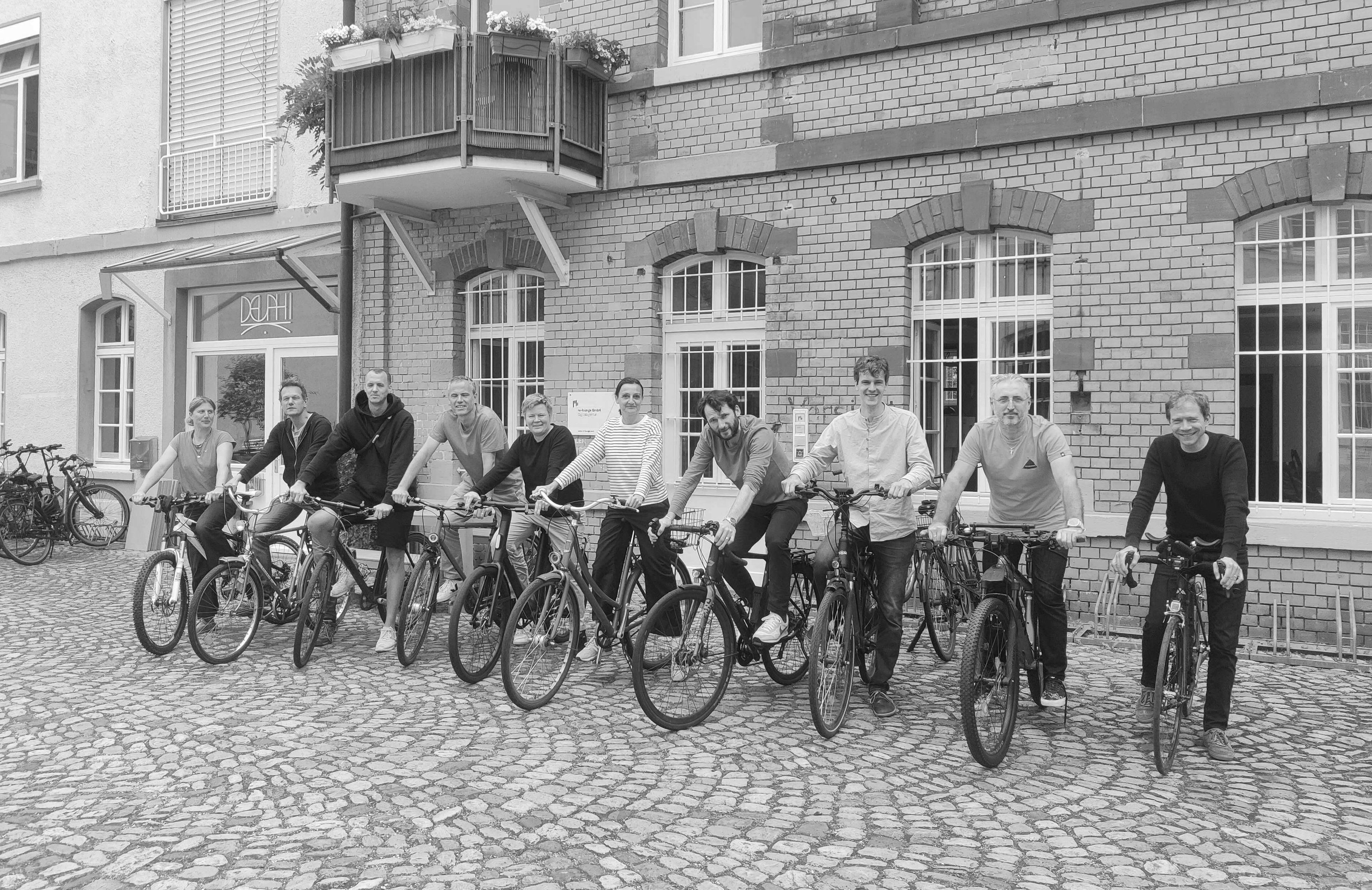 re-lounge Team mit Fahrrädern vor dem Office